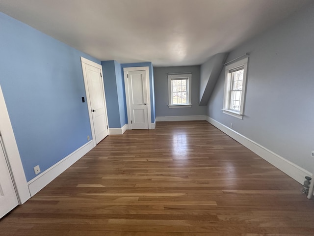 interior space featuring baseboards and wood finished floors