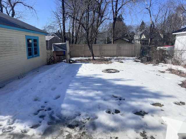 yard layered in snow with fence