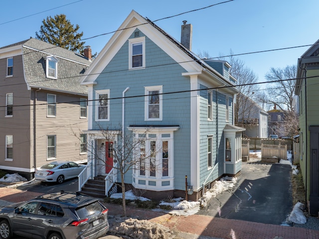 view of front of home featuring a chimney