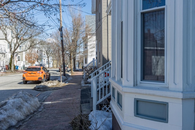 view of street featuring sidewalks, a residential view, and curbs