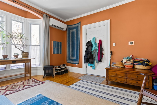 foyer featuring crown molding, wood finished floors, and a wall mounted air conditioner