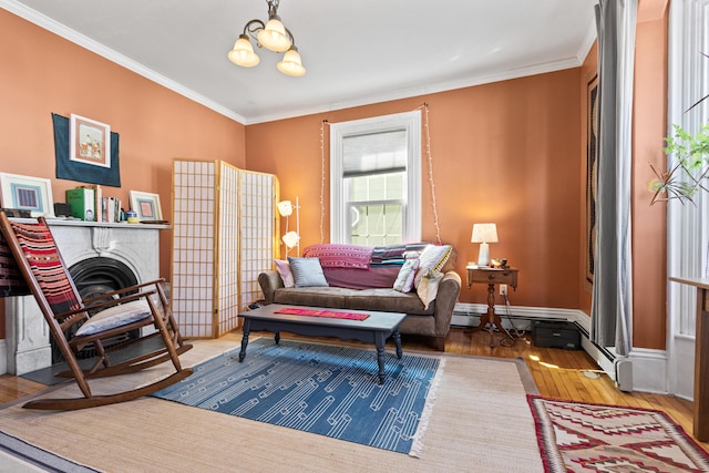 sitting room featuring crown molding, baseboards, a fireplace, hardwood / wood-style flooring, and a notable chandelier