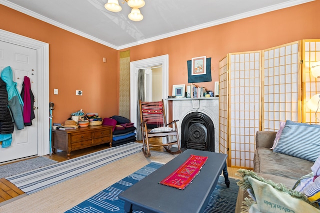 living room featuring wood finished floors, a fireplace, and crown molding