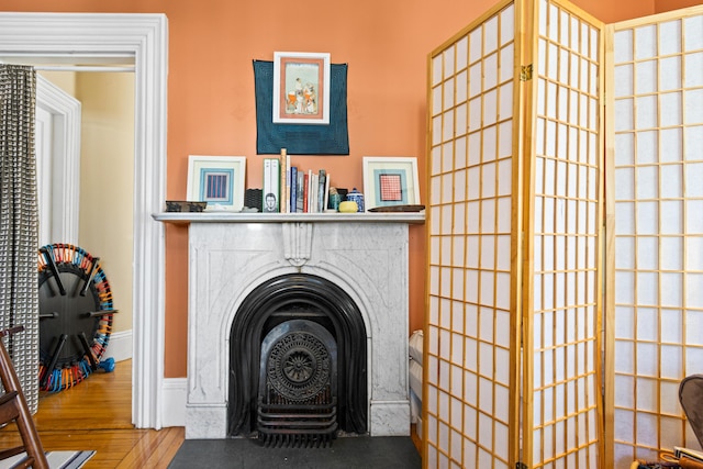 washroom with a fireplace and wood finished floors