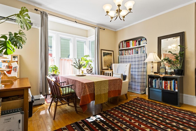 dining area with an inviting chandelier, baseboard heating, wood-type flooring, and ornamental molding