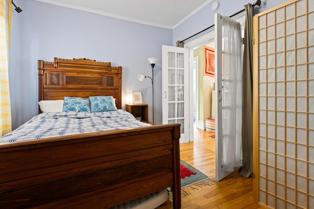 bedroom with wood-type flooring and ornamental molding