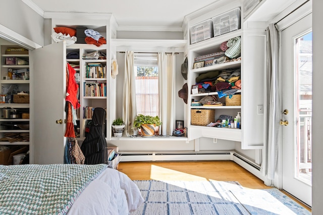 bedroom with wood finished floors and ornamental molding