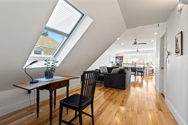 dining room with recessed lighting, baseboards, vaulted ceiling with skylight, and light wood-style floors