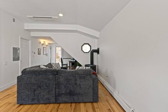 living area featuring visible vents, baseboards, and light wood-style flooring