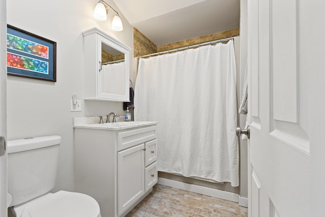 bathroom featuring brick floor, a shower with curtain, toilet, and vanity