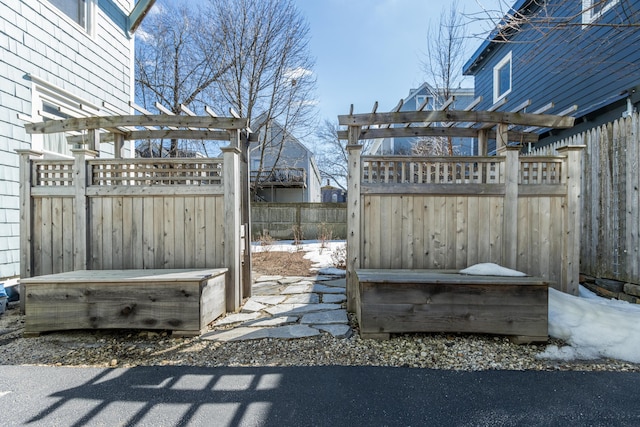 exterior space with a pergola and fence