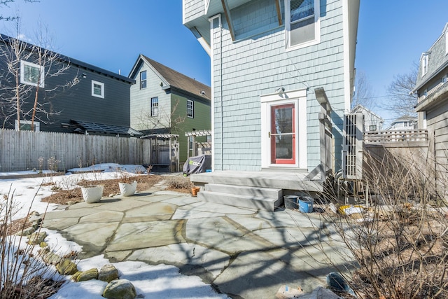 rear view of house with a patio and fence