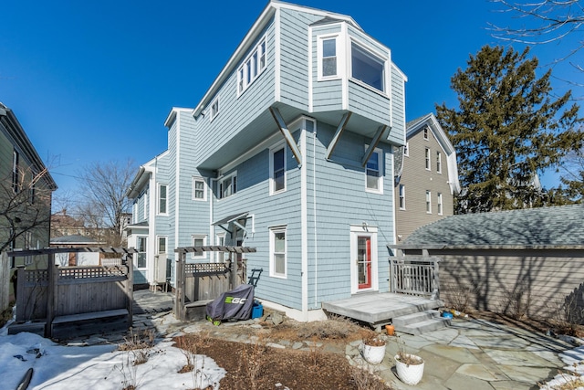 rear view of house with a wooden deck