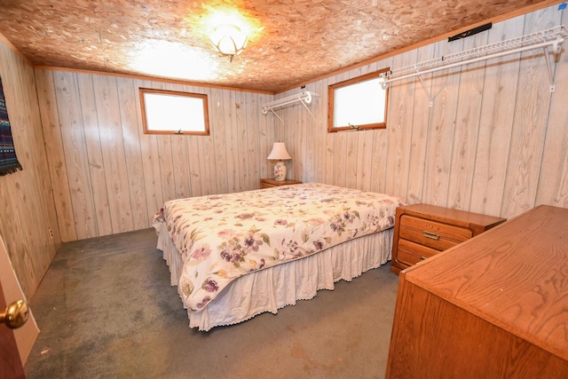 carpeted bedroom featuring wooden walls