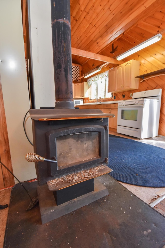 kitchen with lofted ceiling with beams, a wood stove, white range with gas stovetop, wood ceiling, and wood walls