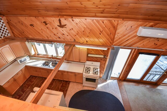 kitchen with white microwave, wooden walls, wall oven, and a sink