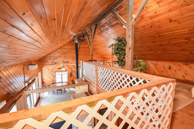 sitting room with an upstairs landing, wood finished floors, wood walls, lofted ceiling, and wood ceiling