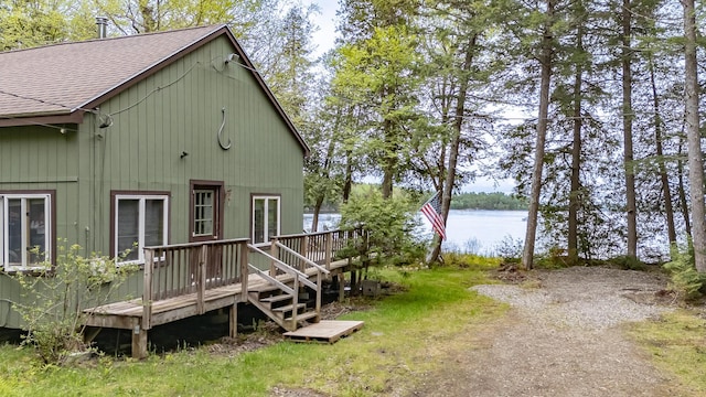345 Tims Cove Rd, Willimantic, ME 04443 - view of home's exterior with roof with shingles and a deck with water view