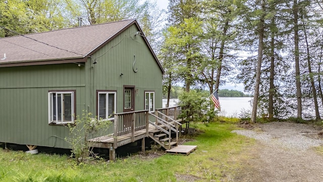 345 Tims Cove Rd, Willimantic, ME 04443 - view of home's exterior with a shingled roof and a deck with water view