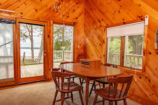 345 Tims Cove Rd, Willimantic, ME 04443 - dining area featuring a water view, wood walls, and lofted ceiling