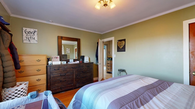 bedroom with light wood-type flooring and ornamental molding