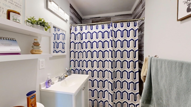 bathroom featuring vanity, a shower with shower curtain, and ornamental molding