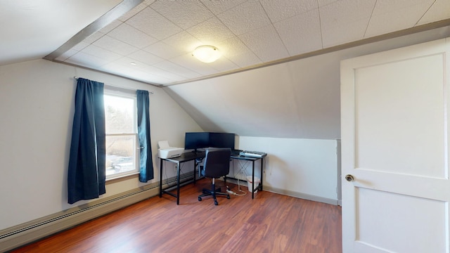 office space with vaulted ceiling, wood finished floors, baseboards, and a baseboard radiator