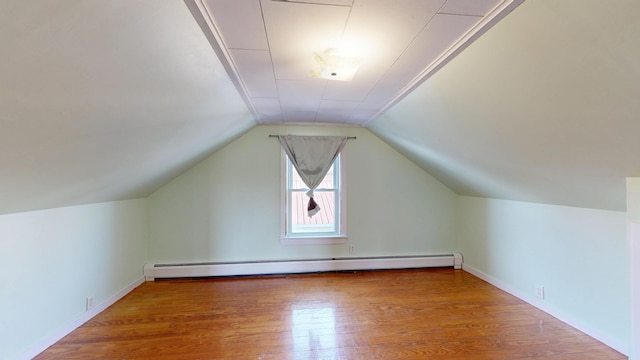 bonus room with a baseboard radiator, wood finished floors, and vaulted ceiling