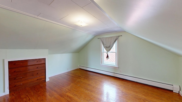 bonus room with a baseboard radiator, wood finished floors, and vaulted ceiling