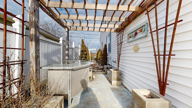 view of patio featuring fence