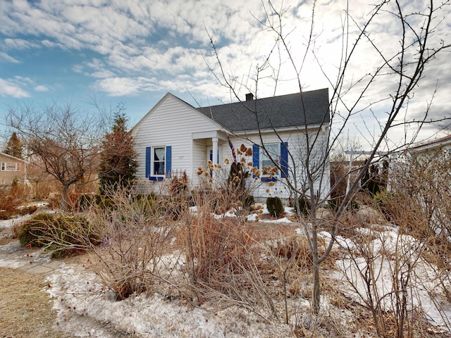 view of side of home featuring a chimney