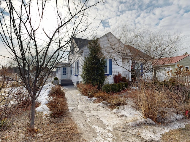 view of side of property featuring entry steps