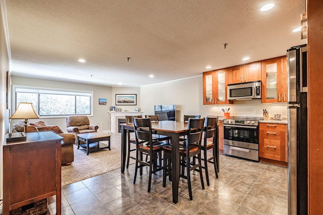 372 Skiway Rd Unit 204, Newry, ME 04261 - dining area with light colored carpet, light tile patterned flooring, a textured ceiling, and recessed lighting