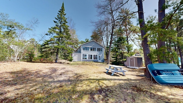 exterior space featuring a shed and an outbuilding
