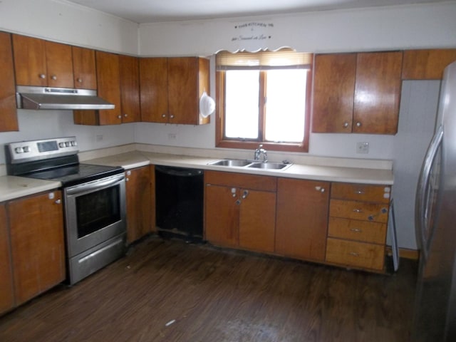 kitchen featuring dark wood-style floors, a sink, appliances with stainless steel finishes, under cabinet range hood, and brown cabinets