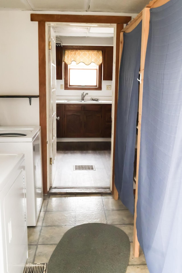 12 Pleasant St, Howland, ME 04448 - bathroom with washing machine and dryer, visible vents, and vanity