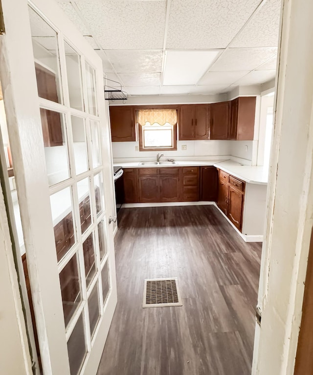 12 Pleasant St, Howland, ME 04448 - kitchen with a paneled ceiling, brown cabinets, visible vents, and a sink