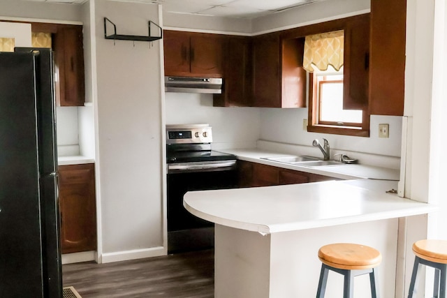 12 Pleasant St, Howland, ME 04448 - kitchen with a sink, freestanding refrigerator, electric range, under cabinet range hood, and dark wood-style floors