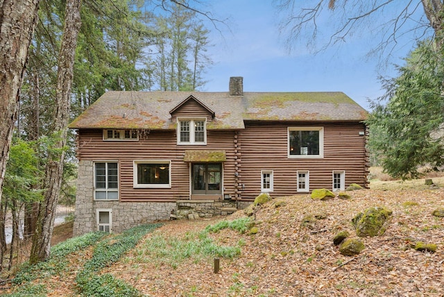 52 Main St, Sanford, ME 04083 - rear view of house featuring stone siding, a chimney, and log siding