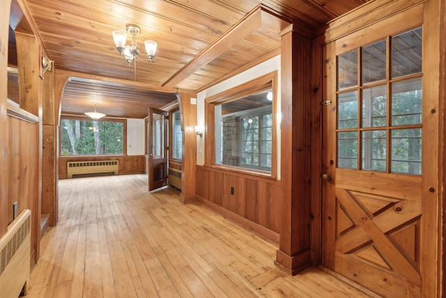 52 Main St, Sanford, ME 04083 - interior space featuring wooden walls, radiator heating unit, wood ceiling, and light wood-style flooring
