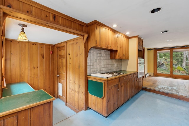 52 Main St, Sanford, ME 04083 - kitchen with gas cooktop, decorative backsplash, brown cabinetry, stainless steel oven, and recessed lighting