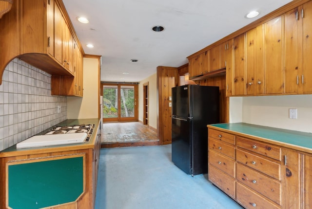 52 Main St, Sanford, ME 04083 - kitchen featuring brown cabinets, freestanding refrigerator, recessed lighting, finished concrete floors, and tasteful backsplash