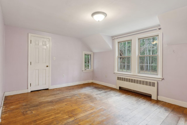 52 Main St, Sanford, ME 04083 - bonus room with baseboards, lofted ceiling, radiator heating unit, and hardwood / wood-style flooring