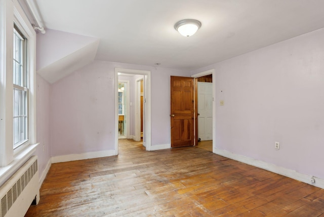52 Main St, Sanford, ME 04083 - additional living space with radiator, baseboards, and wood-type flooring