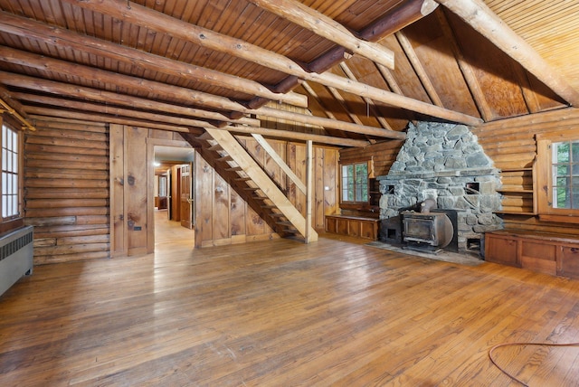 52 Main St, Sanford, ME 04083 - unfurnished living room featuring a wood stove, radiator, hardwood / wood-style floors, beamed ceiling, and wooden ceiling