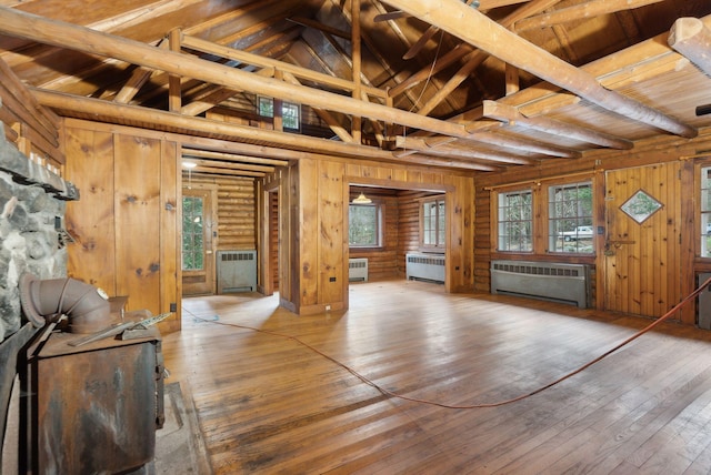 52 Main St, Sanford, ME 04083 - unfurnished living room with wood-type flooring, wood walls, and radiator heating unit
