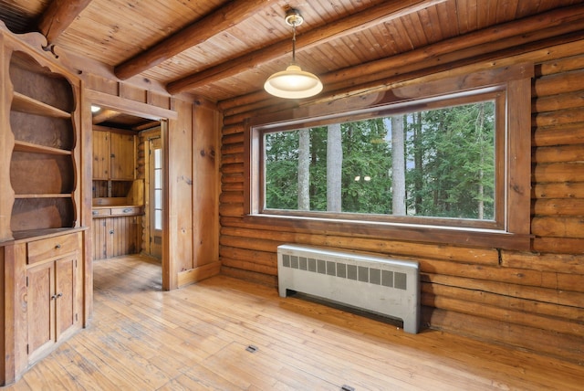 52 Main St, Sanford, ME 04083 - empty room with beam ceiling, wooden ceiling, radiator heating unit, and plenty of natural light