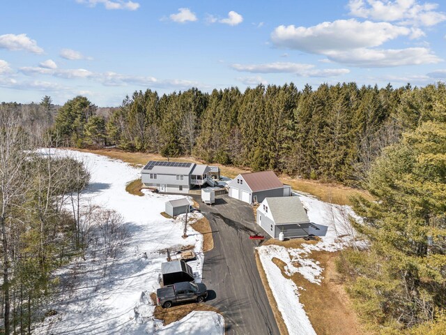 birds eye view of property with a wooded view