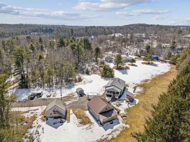 snowy aerial view with a forest view