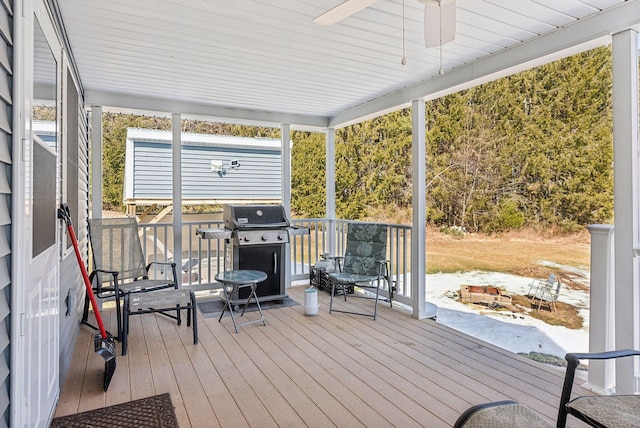 deck with a grill and ceiling fan